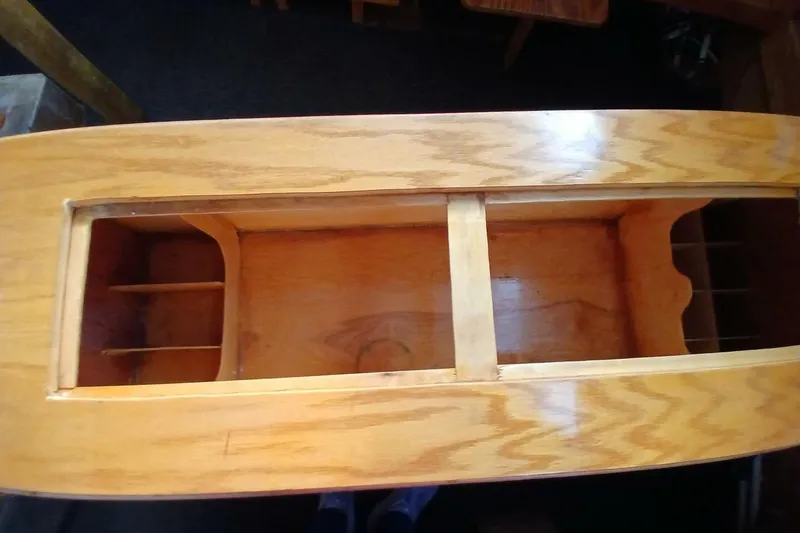 Slide: The Image of 1976 Islander Freeport wooden interior detail with open compartments and smooth finish. - 7