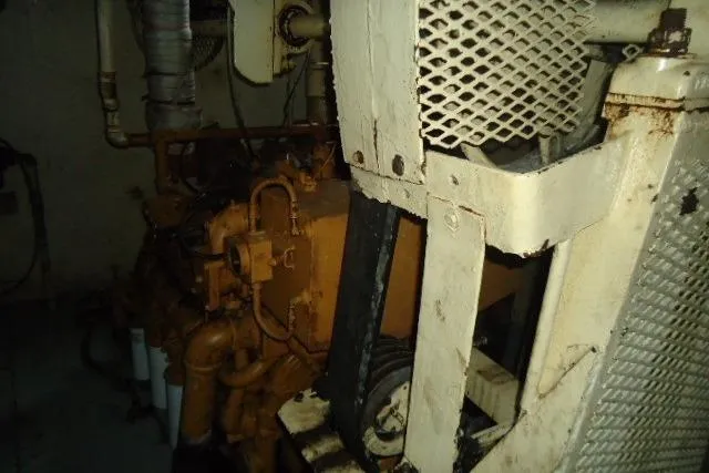 Slide: The Image of Engine room of a 1973 Commercial Boats Shrimp Trawler, showcasing machinery and pipes. - 4