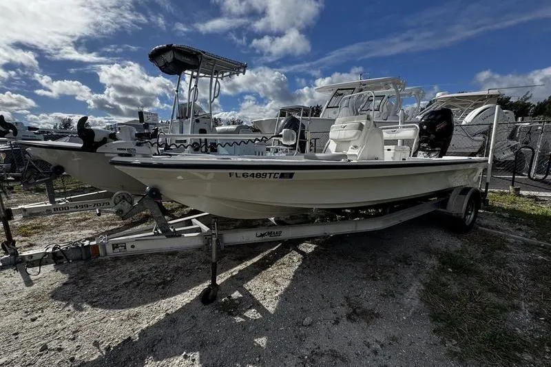 The Image of 2022 Mako 18 LTS boat on trailer under cloudy sky. - 1