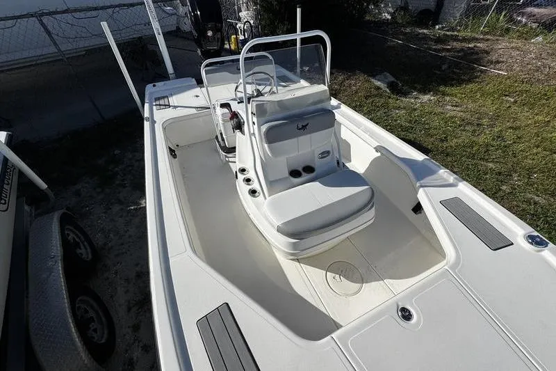 Slide: The Image of 2022 Mako 18 LTS boat with center console and seating, parked outdoors. - 12