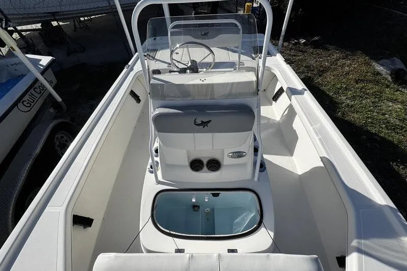 Slide: The Image of 2022 Mako 18 LTS boat interior with steering console and seating area. - 15