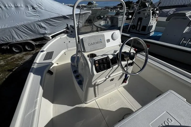 Slide: The Image of 2022 Mako 18 LTS boat interior with Garmin navigation system and steering wheel. - 18