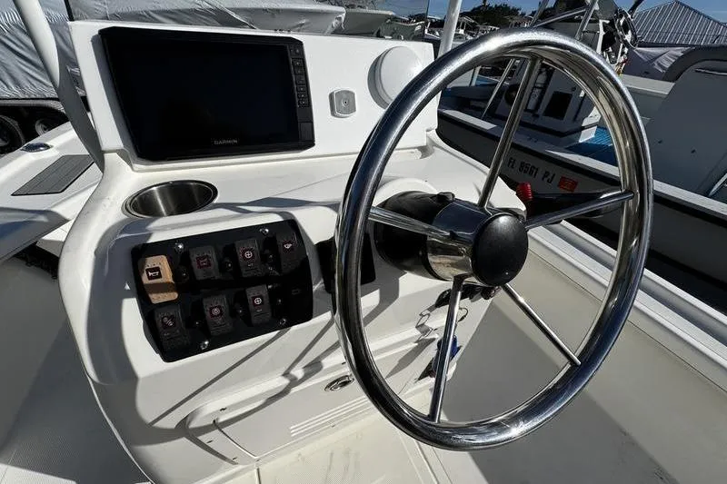 Slide: The Image of 2022 Mako 18 LTS boat steering console with controls and navigation screen. - 20