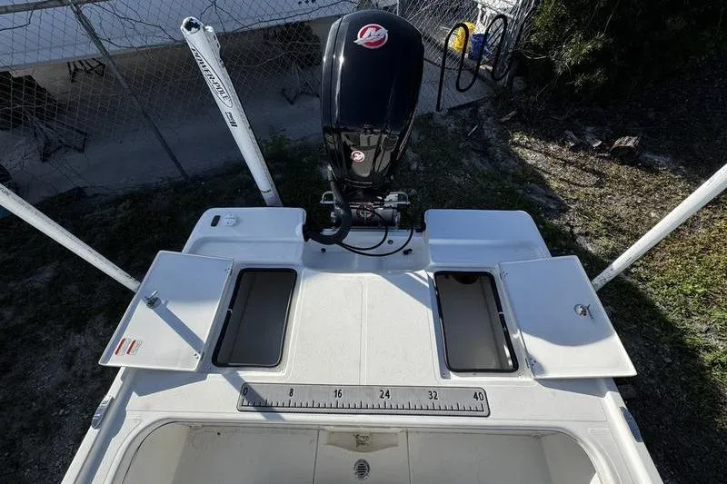 Slide: The Image of 2022 Mako 18 LTS boat with outboard motor and storage compartments. - 24