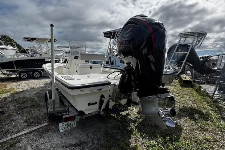 Slide: The Image of 2022 Mako 18 LTS boat with powerful outboard motor, parked on a trailer. - 4