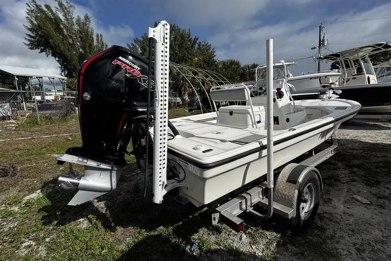 Slide: The Image of 2022 Mako 18 LTS boat on trailer with Mercury engine, parked outdoors. - 5