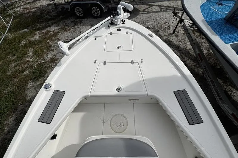 Slide: The Image of 2022 Mako 18 LTS boat deck with storage compartments and trolling motor. - 8