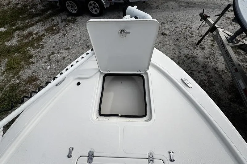 Slide: The Image of Open hatch on 2022 Mako 18 LTS boat deck, showing storage compartment. - 9