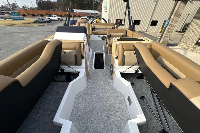 Slide: The Image of 2026 Revel RS25 boat interior with tan seating and modern design. - 11