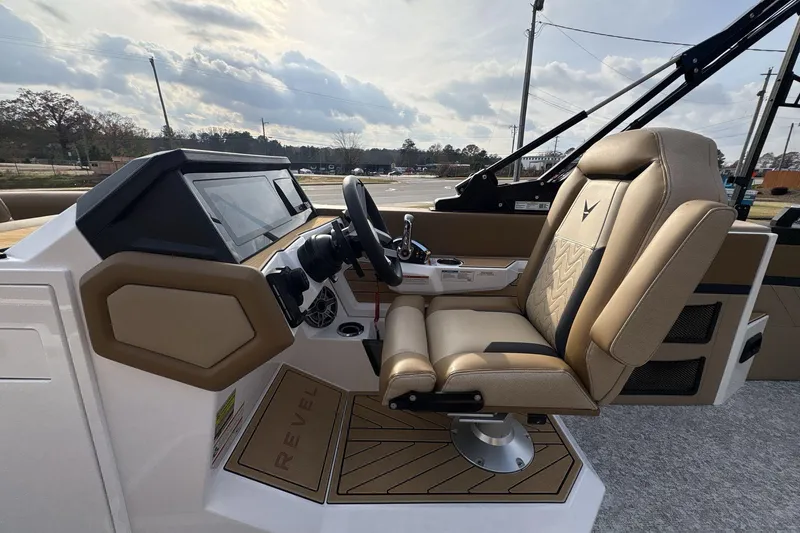 Slide: The Image of 2026 Revel RS25 boat interior with beige captain's seat and modern dashboard. - 12