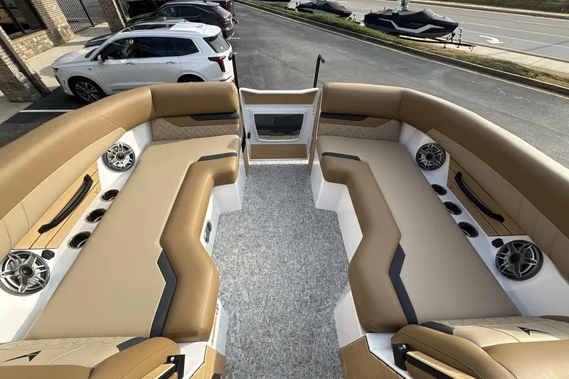 Slide: The Image of Luxurious interior of 2026 Revel RS25 boat with tan seating and modern speakers. - 13