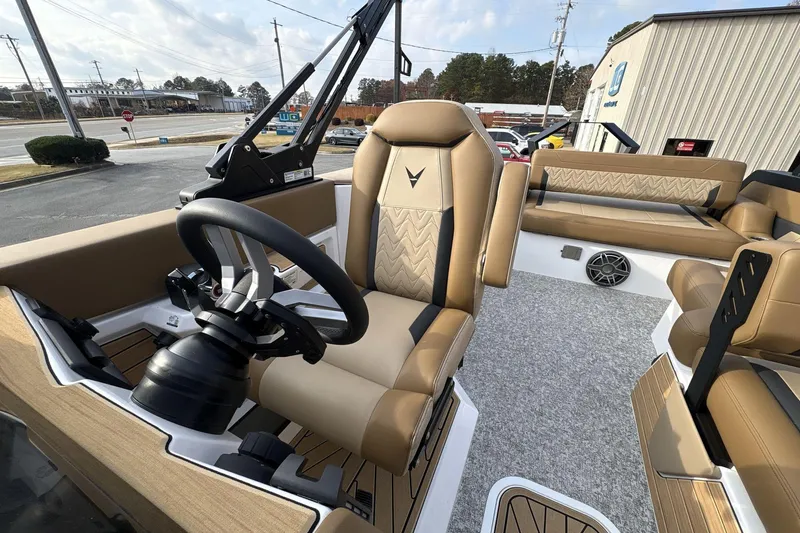 Slide: The Image of 2026 Revel RS25 boat interior with tan leather seats and modern steering wheel. - 14