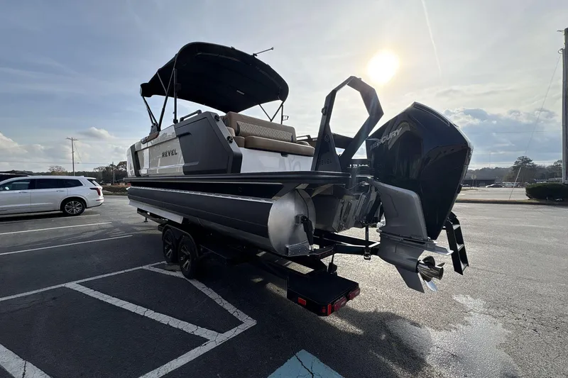 Slide: The Image of 2026 Revel RS25 boat on trailer, parked in a lot under a sunny sky. - 3
