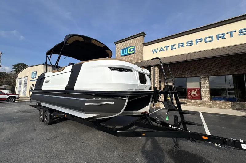 Slide: The Image of 2026 Revel RS25 boat on trailer outside watersports store. - 5
