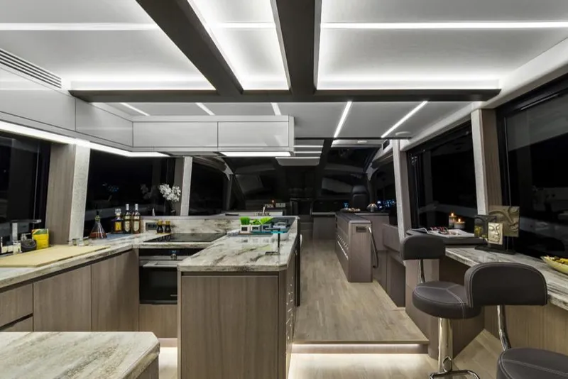 Slide: The Image of Manufacturer Provided Image: Luxurious interior of 2025 Galeon 640 Fly yacht with modern kitchen and seating area. - 13