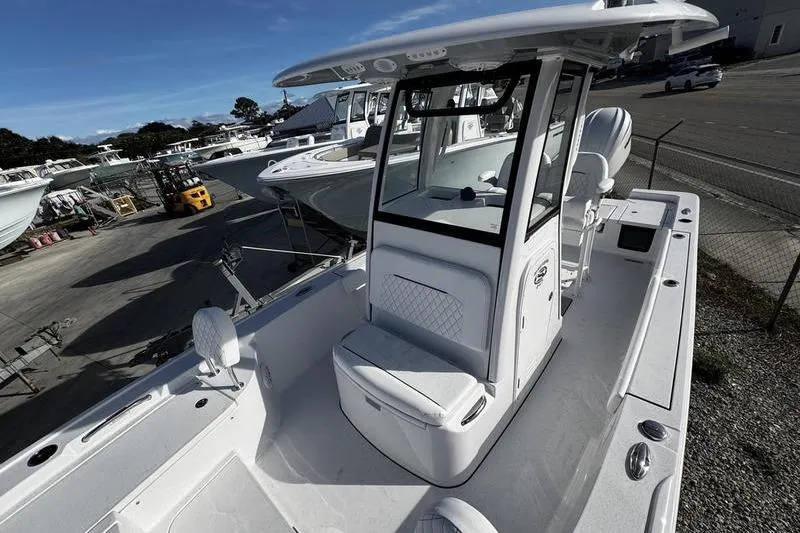 Slide: The Image of 2026 Sportsman Masters 247 Bay Boat, sleek design, spacious deck, parked outdoors. - 10