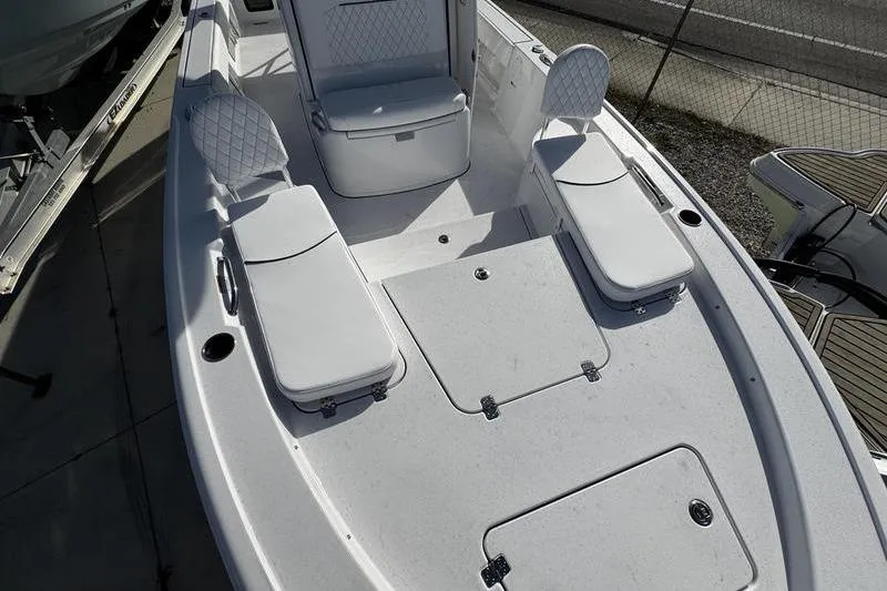 Slide: The Image of 2026 Sportsman Masters 247 Bay Boat interior with cushioned seating and storage compartments. - 11