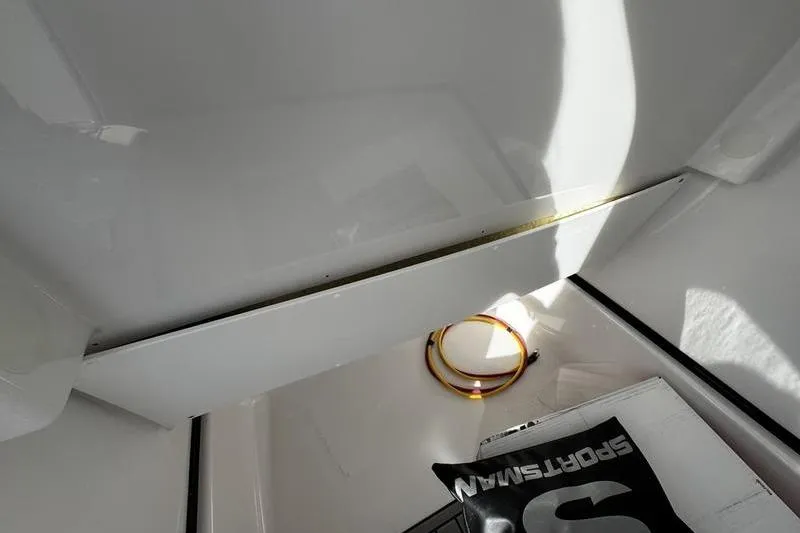 Slide: The Image of Interior view of 2026 Sportsman Masters 247 Bay Boat storage compartment. - 12