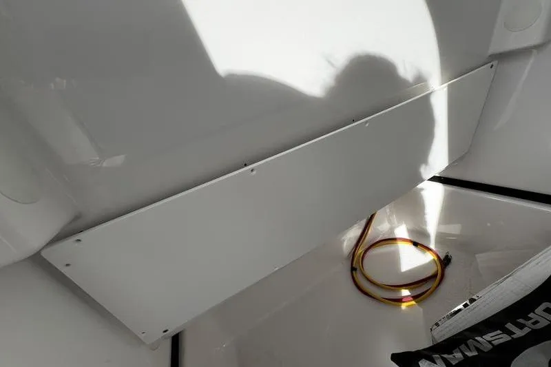 Slide: The Image of 2026 Sportsman Masters 247 Bay Boat interior with coiled cable and shadow. - 13
