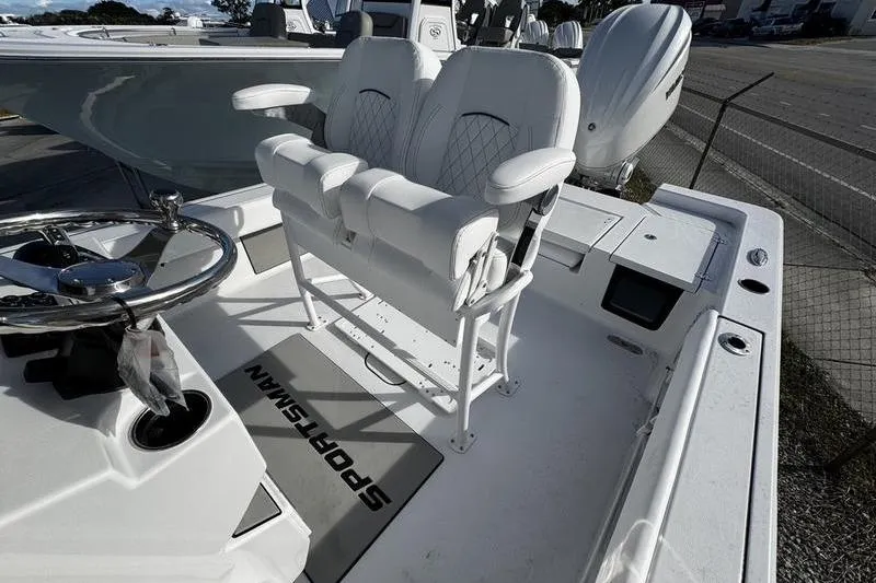 Slide: The Image of 2026 Sportsman Masters 247 Bay Boat with dual white seats and steering wheel. - 15