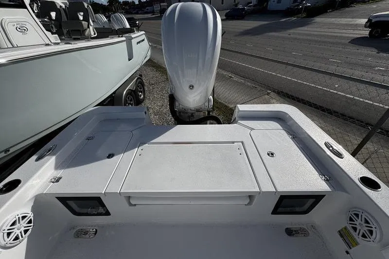 Slide: The Image of 2026 Sportsman Masters 247 Bay Boat with powerful outboard motor, docked outdoors. - 17