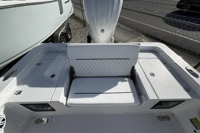 Slide: The Image of 2026 Sportsman Masters 247 Bay Boat, rear seating and storage area, outdoor display. - 18