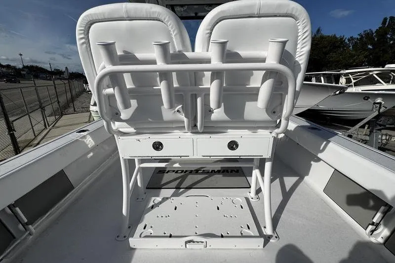 Slide: The Image of 2026 Sportsman Masters 247 Bay Boat interior with dual seats and rod holders. - 19