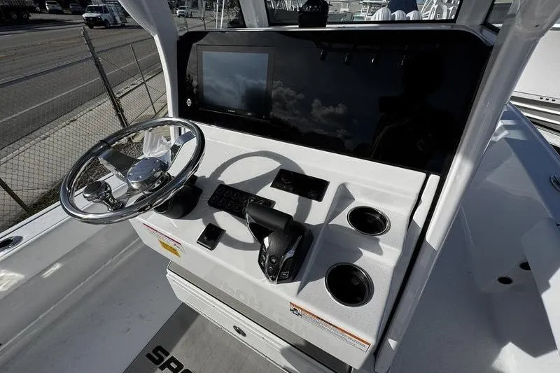 Slide: The Image of 2026 Sportsman Masters 247 Bay Boat helm with steering wheel and control panel. - 22