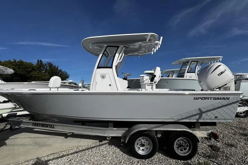 Slide: The Image of 2026 Sportsman Masters 247 Bay Boat on trailer, side view under clear blue sky. - 3