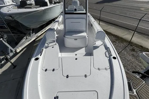 Slide: The Image of 2026 Sportsman Masters 247 Bay Boat with spacious deck and seating, docked outdoors. - 5