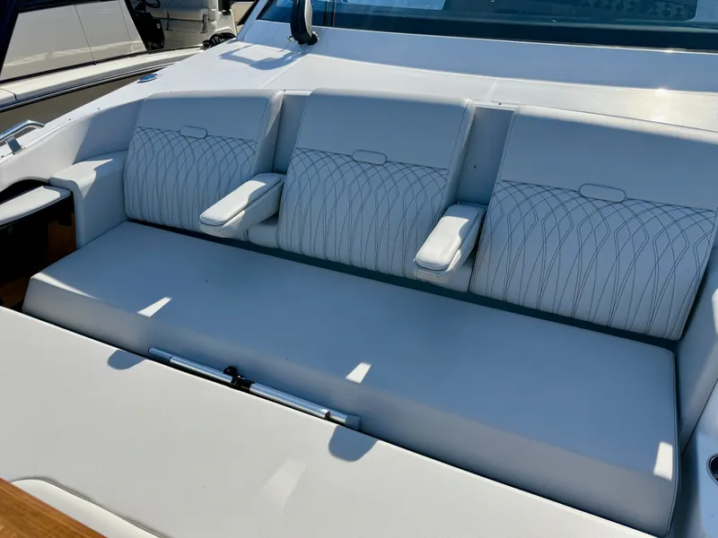 Slide: The Image of The 2026 Sea Ray Sundancer 370 features an elegant white bench seat with armrests. - 15