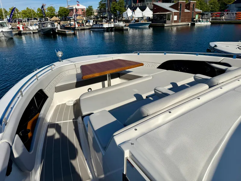 Slide: The Image of The image shows the deck of a 2026 Sea Ray Sundancer 370 in a marina. - 14