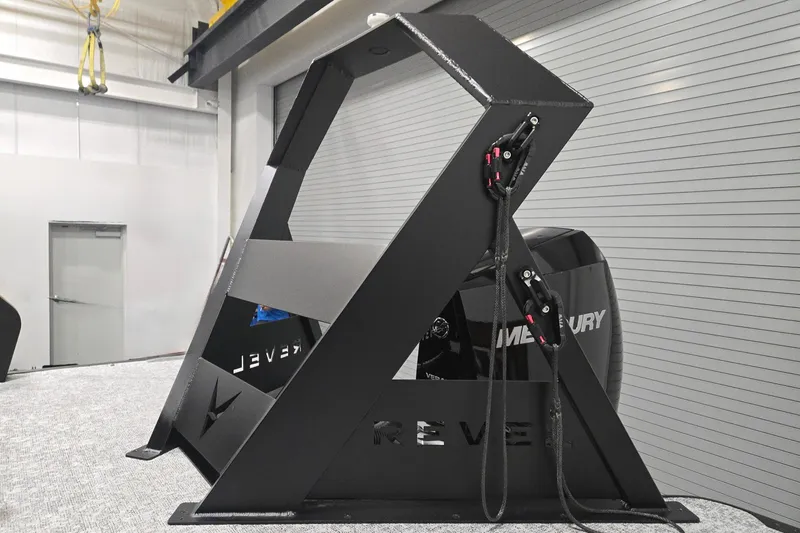 Slide: The Image of Revel RS25 2026 model in a modern industrial setting with Mercury engine. - 4