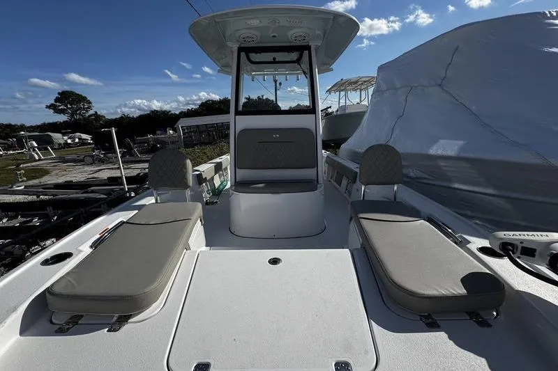 Slide: The Image of 2025 Sportsman Masters 227 Bay Boat with seating and console, docked outdoors. - 10
