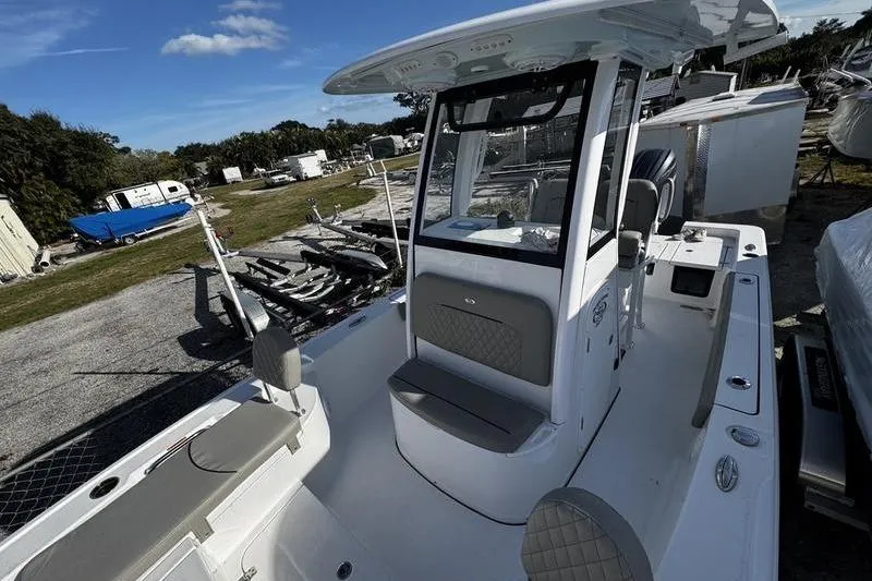 Slide: The Image of 2025 Sportsman Masters 227 Bay Boat storage compartment with electrical components and equipment. - 12