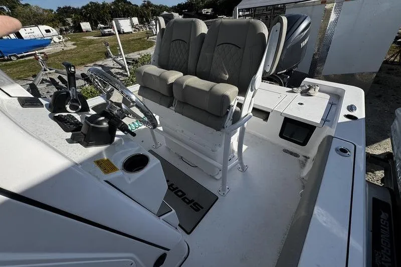 Slide: The Image of 2025 Sportsman Masters 227 Bay Boat interior with dual seats and steering console. - 14