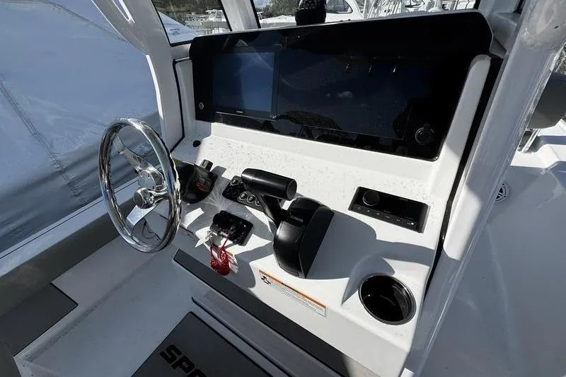 Slide: The Image of 2025 Sportsman Masters 227 Bay Boat, rear deck view with engine and storage compartments. - 18