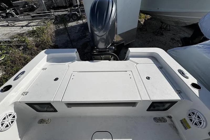 Slide: The Image of 2025 Sportsman Masters 227 Bay Boat with cushioned seating and storage compartments. - 19