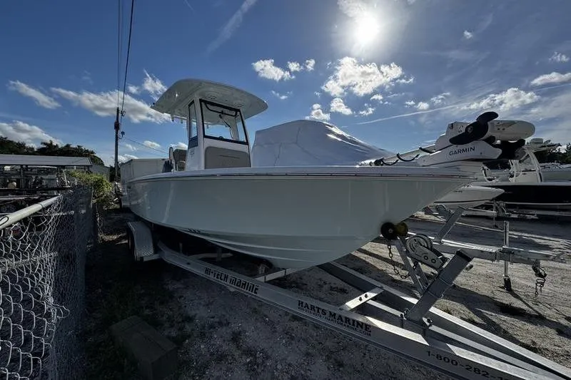 Slide: The Image of 2025 Sportsman Masters 227 Bay Boat with Yamaha 200 engine, parked outdoors. - 2