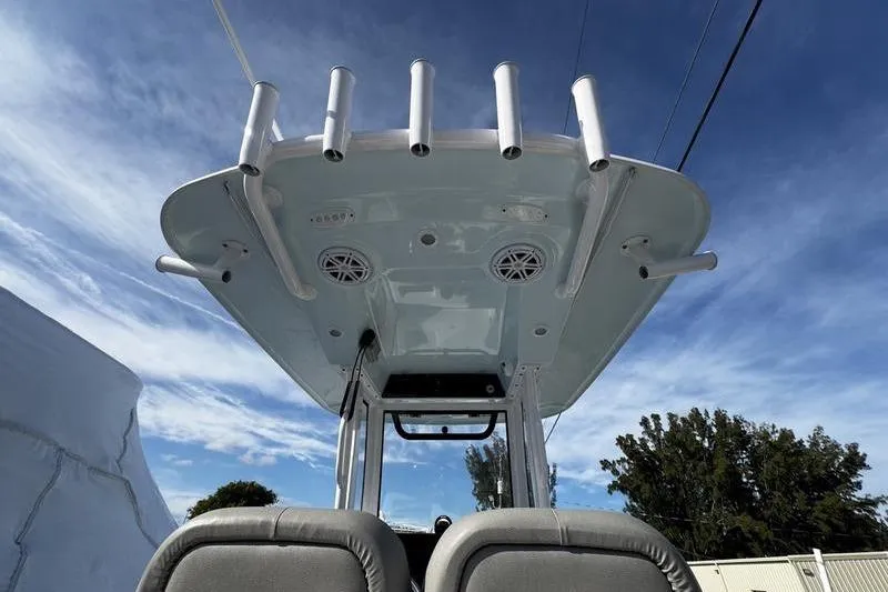 Slide: The Image of 2025 Sportsman Masters 227 Bay Boat interior with rod holders and Engel cooler. - 21