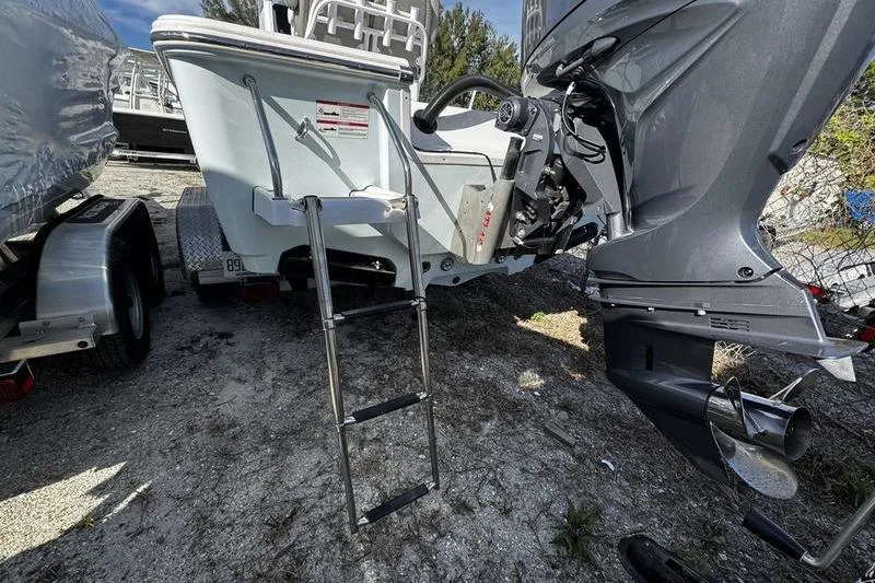 Slide: The Image of 2025 Sportsman Masters 227 Bay Boat docked, featuring spacious deck and seating. - 4