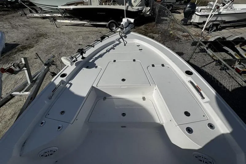 Slide: The Image of 2025 Sportsman Masters 227 Bay Boat, white deck, parked outdoors, showcasing spacious layout. - 7