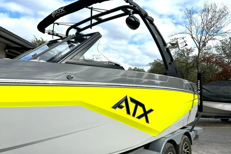 Slide: The Image of 2021 ATX 22 Type-S boat with vibrant yellow and gray design on a trailer. - 11