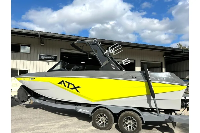 Slide: The Image of 2021 ATX 22 Type-S boat with yellow and gray design on a trailer. - 12