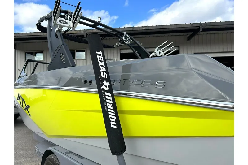 Slide: The Image of 2021 ATX 22 Type-S boat with vibrant yellow and gray design, Texas Malibu branding. - 14