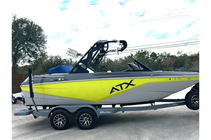 Slide: The Image of 2021 ATX 22 Type-S boat with vibrant yellow and gray design on a trailer. - 15