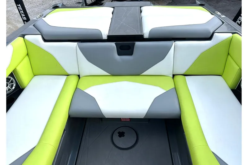 Slide: The Image of 2021 ATX 22 Type-S boat interior with lime green, white, and gray seating. - 25