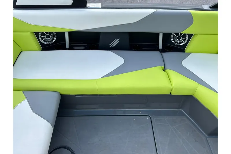 Slide: The Image of ATX 22 Type-S 2021 boat interior with green and gray seating, featuring built-in speakers. - 36