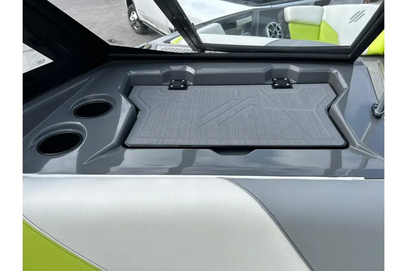 Slide: The Image of 2021 ATX 22 Type-S boat interior with cup holders and storage compartment. - 38