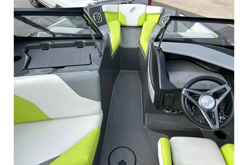 Slide: The Image of 2021 ATX 22 Type-S boat interior with lime green and gray seating, modern steering wheel. - 40